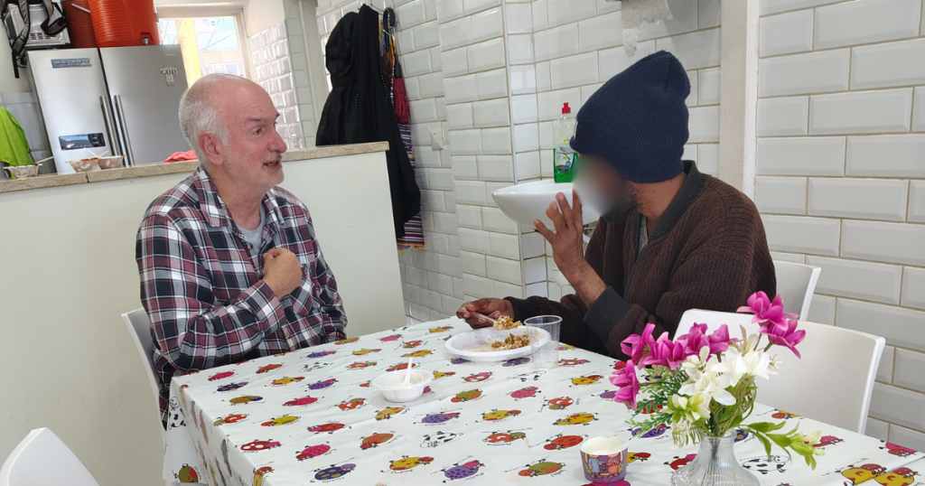 Pastor Ronnie and Abraham in conversation at the KBN Israel soup kitchen Tel Aviv